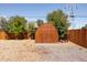 Image of a wooden shed with a peaked roof and double doors in a backyard with a gravel base at 5915 W 5Th Ave, Lakewood, CO 80226