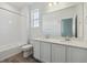Bright bathroom with double vanity, quartz countertops, tiled shower and ample lighting at 6646 N Nepal St, Aurora, CO 80019