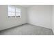 Bright, carpeted bedroom featuring a large window and neutral paint at 6646 N Nepal St, Aurora, CO 80019
