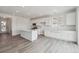 Spacious, all-white kitchen featuring a large island, plentiful cabinet space, and modern finishes at 6646 N Nepal St, Aurora, CO 80019