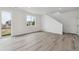 Unfurnished living space with wood floors, large windows, and access to the upper level at 6646 N Nepal St, Aurora, CO 80019