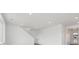 Bright, open living space with a staircase, light wood floors, and freshly painted white walls at 6646 N Nepal St, Aurora, CO 80019