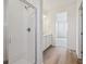 Bright bathroom featuring a tiled shower with a glass enclosure and modern fixtures at 6646 N Nepal St, Aurora, CO 80019