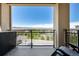 Balcony with comfortable furniture, black railings and sweeping views of the valley and mountains at 9258 Rockhurst St # 303, Highlands Ranch, CO 80129