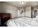 Neutral bedroom features a dresser, walk-in closet, and view to the en-suite bathroom at 9258 Rockhurst St # 303, Highlands Ranch, CO 80129
