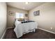 Neutral bedroom with carpet, a teddy bear on the bed and artwork hanging on the walls at 9258 Rockhurst St # 303, Highlands Ranch, CO 80129
