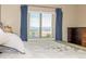 Bedroom mountain view from the window with blue curtains and a dark wood dresser at 9258 Rockhurst St # 303, Highlands Ranch, CO 80129