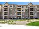Beautiful condo building featuring brick accents and private balconies at 9258 Rockhurst St # 303, Highlands Ranch, CO 80129