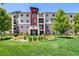 Inviting apartment building entrance with manicured lawns and vibrant landscaping at 9258 Rockhurst St # 303, Highlands Ranch, CO 80129
