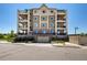Condo building with a parking garage and manicured landscaping at 9258 Rockhurst St # 303, Highlands Ranch, CO 80129