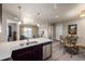 Open-concept kitchen with stainless steel appliances and a dining area with seating at 9258 Rockhurst St # 303, Highlands Ranch, CO 80129