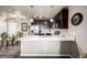 Modern kitchen with stainless steel appliances, dark cabinetry, and adjacent dining area at 9258 Rockhurst St # 303, Highlands Ranch, CO 80129