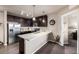 Modern kitchen with stainless steel appliances, dark wood cabinets, and a breakfast bar at 9258 Rockhurst St # 303, Highlands Ranch, CO 80129