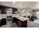 Contemporary kitchen with stainless appliances, open to the living area and balcony, with modern cabinets at 9258 Rockhurst St # 303, Highlands Ranch, CO 80129