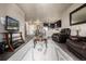 Spacious living room featuring comfortable seating and views of the kitchen at 9258 Rockhurst St # 303, Highlands Ranch, CO 80129