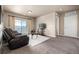 Well-lit living room boasts a sliding glass door and a balcony at 9258 Rockhurst St # 303, Highlands Ranch, CO 80129
