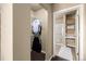 Walk-in closet includes shelving and hanging storage that is accessible from the bathroom at 9258 Rockhurst St # 303, Highlands Ranch, CO 80129