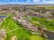 Panoramic aerial view of a lush green golf course and residential neighborhood under a clear sky at 11489 W Bear Creek Dr, Lakewood, CO 80227