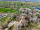 Picturesque single-story home with well-manicured lawn and mature trees, backing to golf course at 11489 W Bear Creek Dr, Lakewood, CO 80227