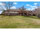 Large, manicured backyard with a stone facade and a spacious deck for outdoor enjoyment at 11489 W Bear Creek Dr, Lakewood, CO 80227