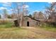Exterior view of a two-story barn with a sliding door and fenced pasture at 11489 W Bear Creek Dr, Lakewood, CO 80227
