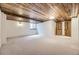Finished basement featuring carpet flooring, a drop ceiling, and natural wood doors at 11489 W Bear Creek Dr, Lakewood, CO 80227