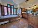 This bathroom boasts an abundance of windows surrounding a soaking tub and dual sink vanity with granite countertops at 11489 W Bear Creek Dr, Lakewood, CO 80227