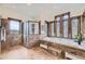 Bright bathroom features large windows, a soaking tub, and a glass-enclosed shower with tiled walls at 11489 W Bear Creek Dr, Lakewood, CO 80227