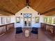 Inviting covered deck with comfortable seating and a wood-paneled vaulted ceiling at 11489 W Bear Creek Dr, Lakewood, CO 80227