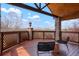 Inviting deck with stone pillars, wood railing, and comfortable seating at 11489 W Bear Creek Dr, Lakewood, CO 80227