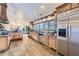 Modern kitchen with stainless steel appliances, custom cabinets, and hardwood floors at 11489 W Bear Creek Dr, Lakewood, CO 80227
