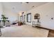 Open living room features a large sofa, windows, carpet floors, and modern decor at 11489 W Bear Creek Dr, Lakewood, CO 80227
