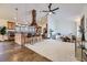 Open-concept living area showcasing kitchen island, a spacious living room, and carpet floors at 11489 W Bear Creek Dr, Lakewood, CO 80227