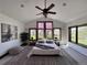 Serene main bedroom featuring vaulted ceilings, natural light, and views of the property at 11489 W Bear Creek Dr, Lakewood, CO 80227