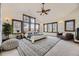 Spacious main bedroom with vaulted ceilings, many windows with golf course views, and comfortable seating at 11489 W Bear Creek Dr, Lakewood, CO 80227