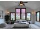 Cozy main bedroom with natural light, neutral tones, and views of outdoor foliage at 11489 W Bear Creek Dr, Lakewood, CO 80227