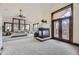 Bright main bedroom with large windows, vaulted ceiling, and a cozy fireplace with a view at 11489 W Bear Creek Dr, Lakewood, CO 80227