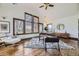 Well-lit office space with large windows and sleek modern furniture on hardwood floor at 11489 W Bear Creek Dr, Lakewood, CO 80227