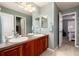 Bright bathroom with a double sink vanity, tiled floors, and neutral colored walls at 16824 E Lake Pl, Aurora, CO 80016