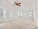 Spacious bedroom with ample natural light from multiple windows and a ceiling fan at 7447 Soapstone Way, Castle Rock, CO 80108