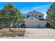 Inviting two-story home featuring a three-car garage and well-maintained landscaping at 7447 Soapstone Way, Castle Rock, CO 80108