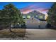 Two-story home with a three-car garage and mature landscaping, set against a sunset sky at 7447 Soapstone Way, Castle Rock, CO 80108