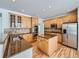 Spacious kitchen with wood cabinets, granite counters, stainless appliances, and a center island at 7447 Soapstone Way, Castle Rock, CO 80108
