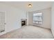 Cozy room featuring a fireplace, neutral carpet, and natural light from the window at 7447 Soapstone Way, Castle Rock, CO 80108