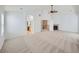 Large living room with neutral carpet, arched doorways, a fireplace, and an open layout at 7447 Soapstone Way, Castle Rock, CO 80108