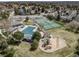 Stunning aerial view of community amenities: pool, tennis courts, and playground. Beautiful neighborhood setting at 18263 E Berry Dr, Centennial, CO 80015