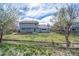 Enjoy the spacious backyard, featuring a lush lawn, mature trees, and garden beds for outdoor enjoyment at 18263 E Berry Dr, Centennial, CO 80015