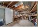 Unfinished basement with exposed ceiling, storage, and shelving at 18263 E Berry Dr, Centennial, CO 80015