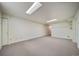 Finished basement featuring neutral carpeting, lighting, and great space for storage at 18263 E Berry Dr, Centennial, CO 80015