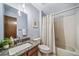Bathroom features a shower-tub combination, granite counter, bright light, and modern fixtures at 18263 E Berry Dr, Centennial, CO 80015